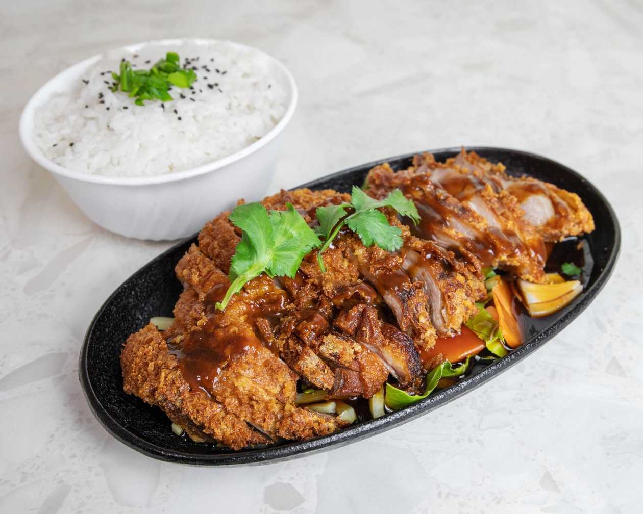 Crispy duck with fried vegetables and Hoisin sauce, served with rice
