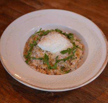 Oatmeal with poached egg, parmesan, truffle oil, and arugula