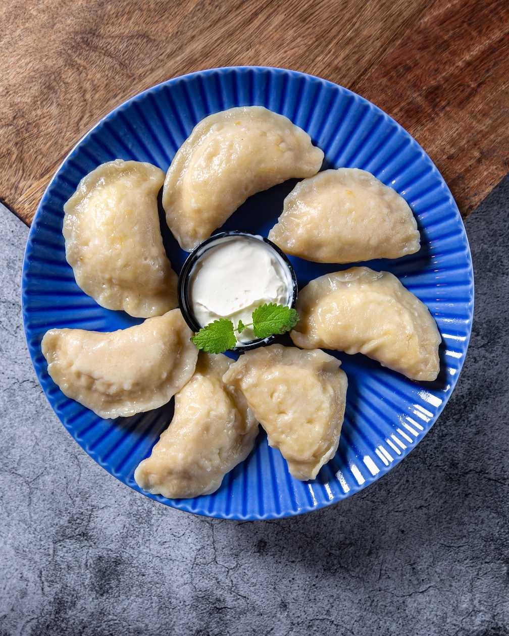 Dumplings with berries and fresh cream